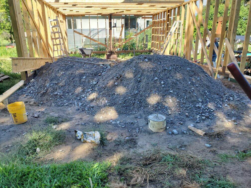 Barn site before clearing — overgrown and cluttered